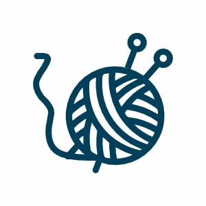 Wollknäuel mit Stricknadeln